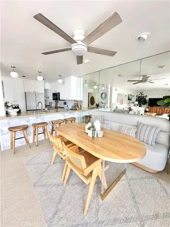 a dining room with wooden floor and chandelier