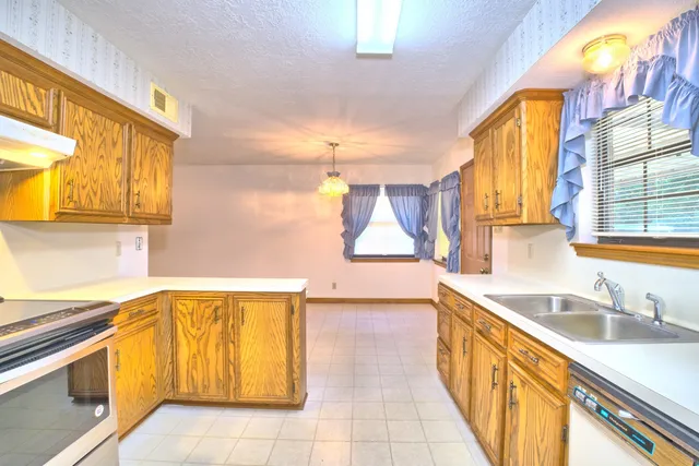 a kitchen with a sink and a window