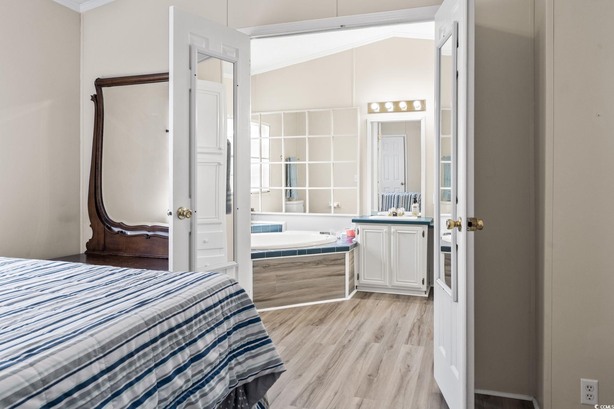 6350 Antioch Road Conway, SC 29527 - Photo 14 of 23 Bedroom with connected bathroom, light wood-style