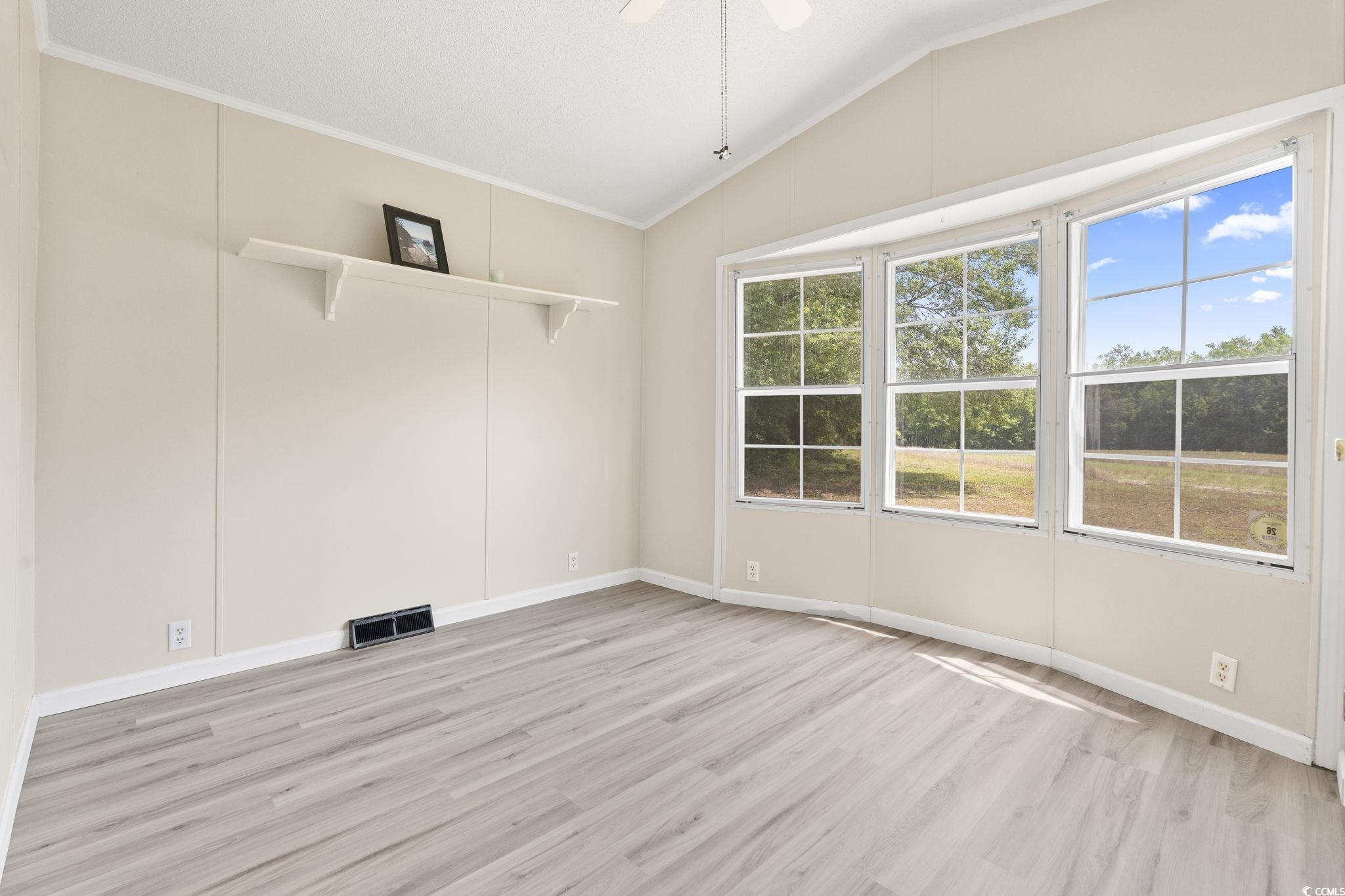 6350 Antioch Road Conway, SC 29527 - Photo 20 of 23 Empty room with lofted ceiling, light wood-style f