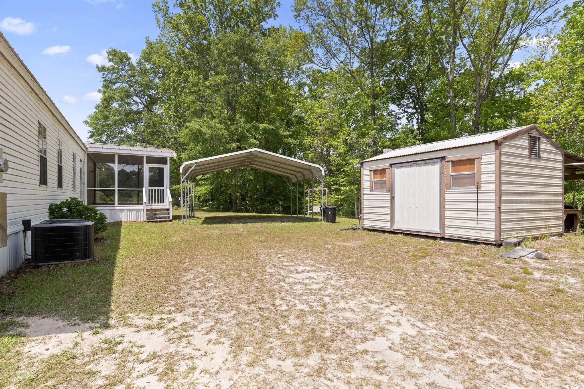 6350 Antioch Road Conway, SC 29527 - Photo 23 of 23 View of yard featuring central AC unit, a storage