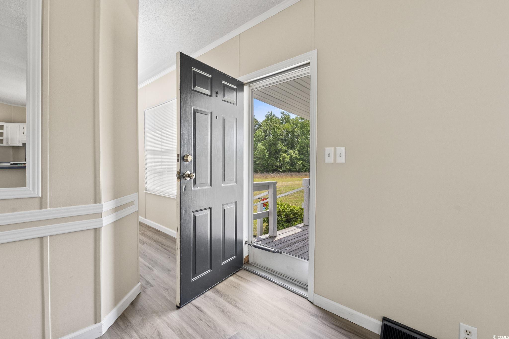6350 Antioch Road Conway, SC 29527 - Photo 5 of 23 Entryway featuring baseboards, crown molding, and