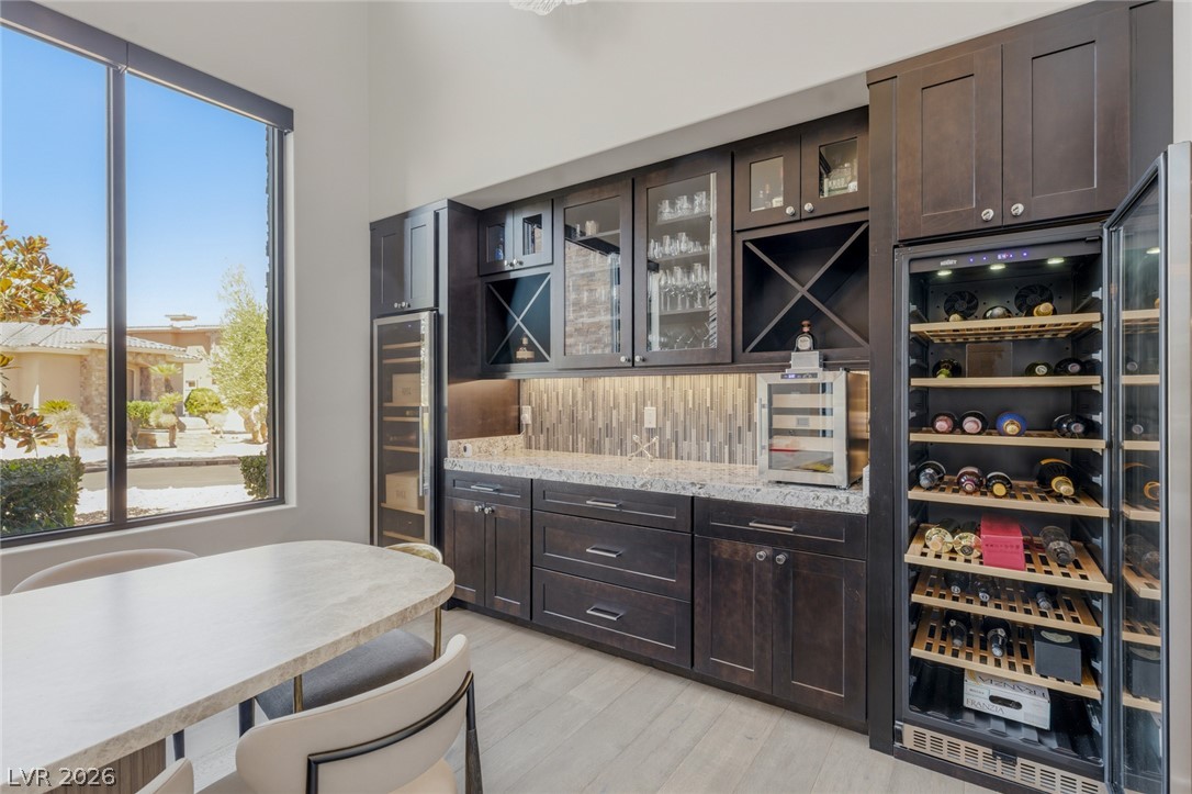 5 Crystal Tree Pass Henderson, NV 89052 - Photo 10 of 67 Custom cabinetry and ample storage define this elegant wine bar, perfectly illuminated for showcasing your collection.