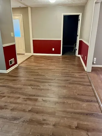 a view of room with window and wooden floor