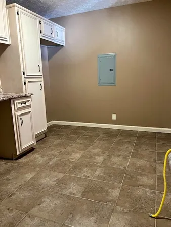 a view of a storage & utility room with a refrigerator