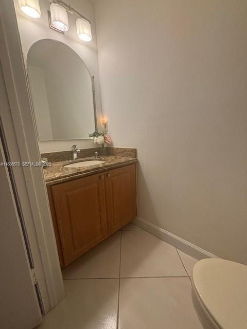 12149 Quilting Lane Boca Raton, FL 33428 - Photo 12 of 36 a bathroom with a toilet sink and mirror