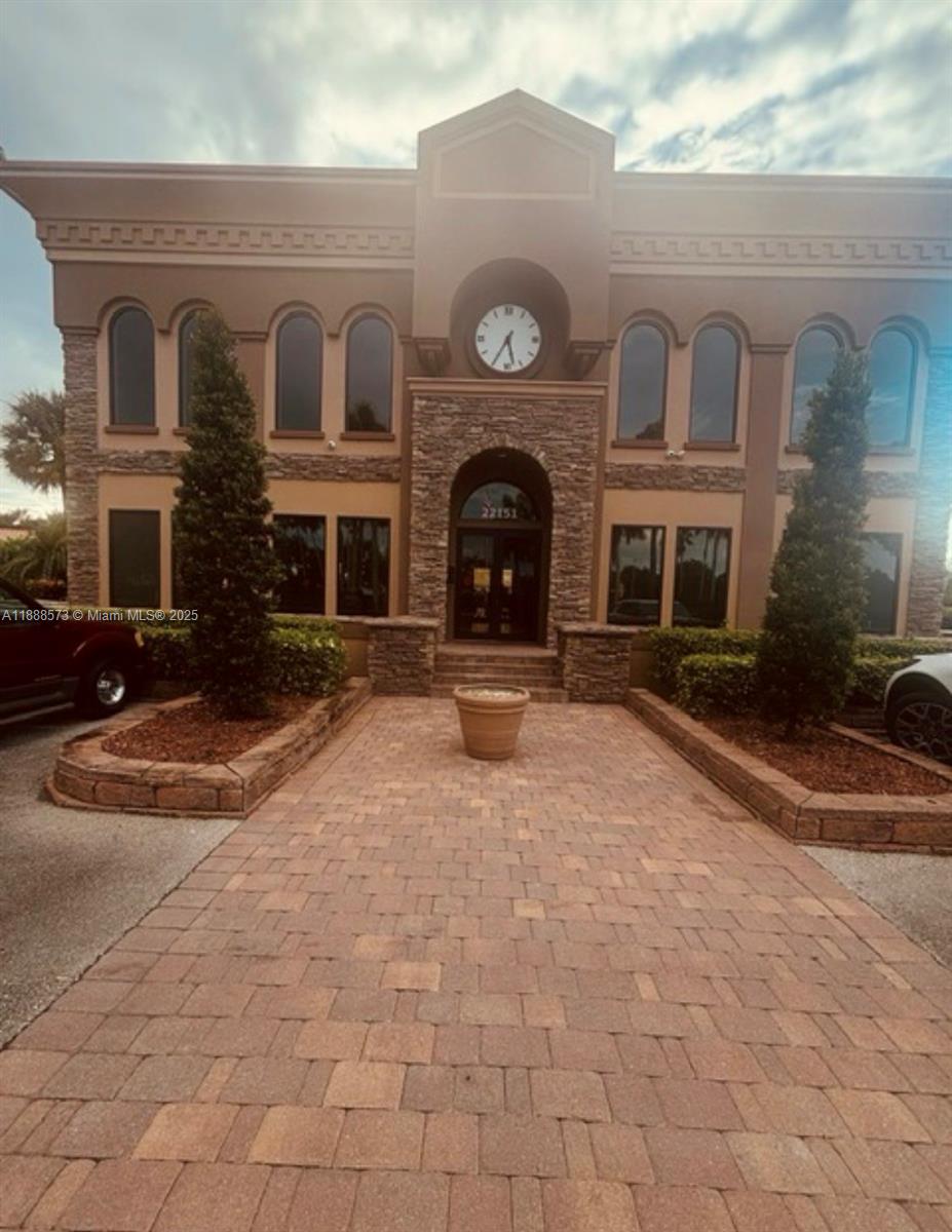 12149 Quilting Lane Boca Raton, FL 33428 - Photo 30 of 36 a view of a brick building with many windows