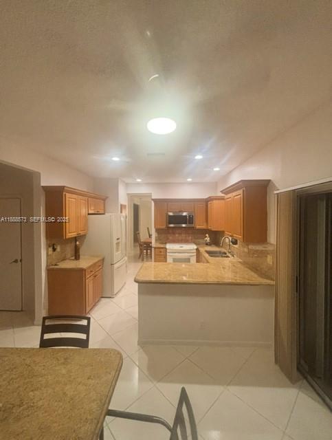 12149 Quilting Lane Boca Raton, FL 33428 - Photo 10 of 36 a large kitchen with a table and chairs