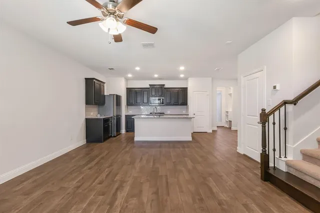a view of kitchen with wooden floor and electronic appliances