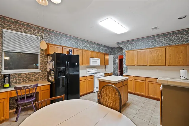a kitchen with a sink appliances and cabinets