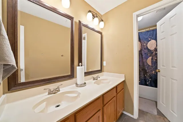 a bathroom with a sink double vanity and a mirror