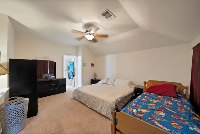 a bedroom with two beds and a chandelier
