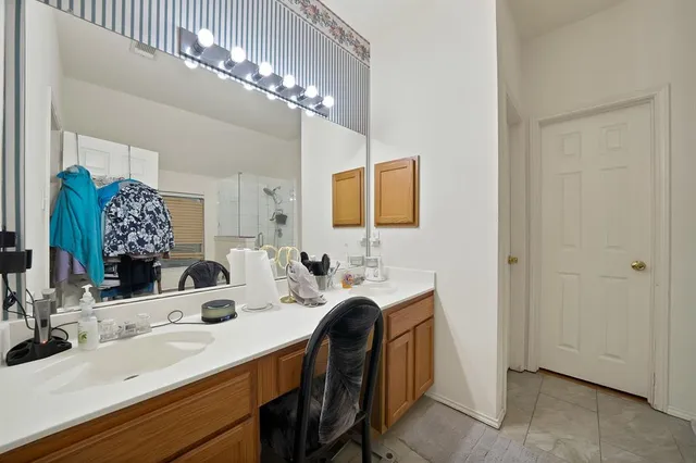 a bathroom with a double vanity sink and a mirror