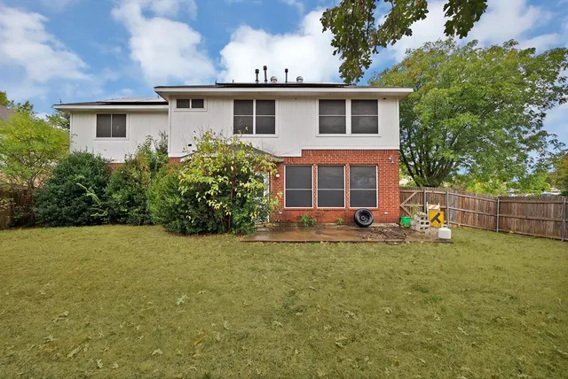 a view of a house with a yard and sitting space