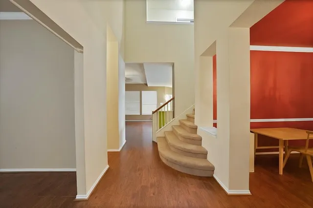 a view of entryway and hall with wooden floor