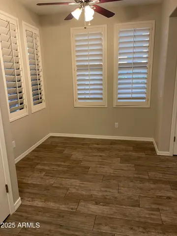 an empty room with wooden floor and fireplace