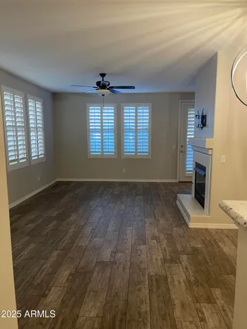 a view of empty room with a kitchen and chandelier