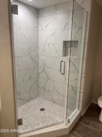 a bathroom with a granite countertop sink a toilet and bathtub