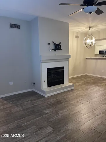 a view of a room with wooden floor and a window