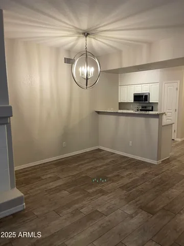 a kitchen with kitchen island a counter top space appliances and a window