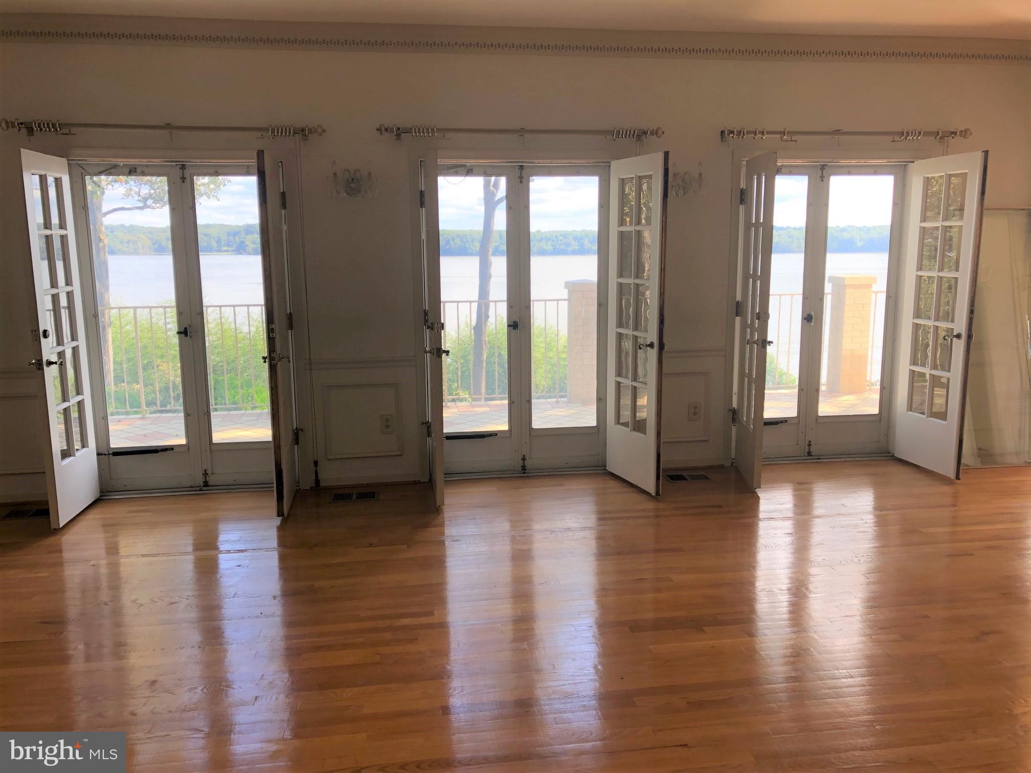 3901 Belle Rive Terrace Alexandria, VA 22309 - Photo 13 of 16 a view of an empty room with wooden floor and a window