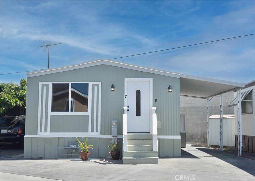8723 Artesia Boulevard, Unit 7 Bellflower, CA 90706 - Photo 2 of 10 a front view of a house with a yard