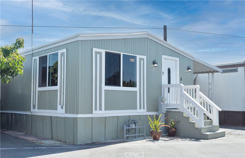 8723 Artesia Boulevard, Unit 7 Bellflower, CA 90706 - Photo 3 of 10 a front view of a house with a garage