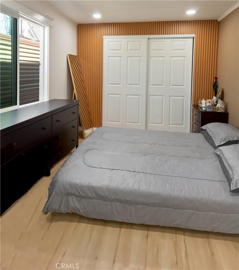 8723 Artesia Boulevard, Unit 7 Bellflower, CA 90706 - Photo 8 of 10 a bedroom with a bed dresser and a window