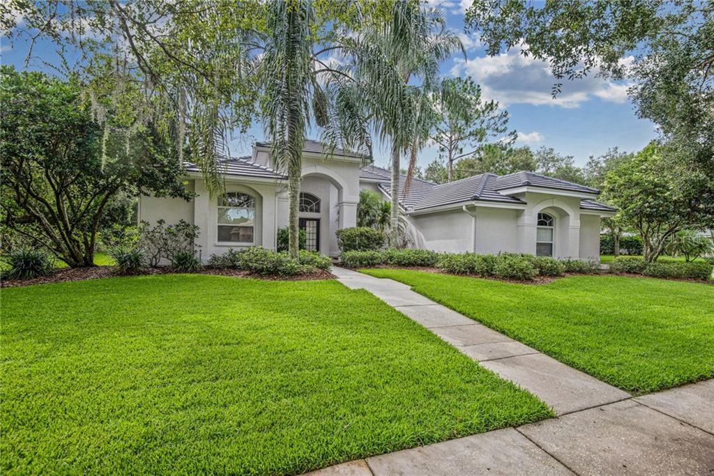 9161 Highland Ridge Way Tampa, FL 33647 - Photo 1 of 1 a front view of a house with a garden
