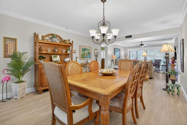 a view of a a dining room with furniture window and wooden floor