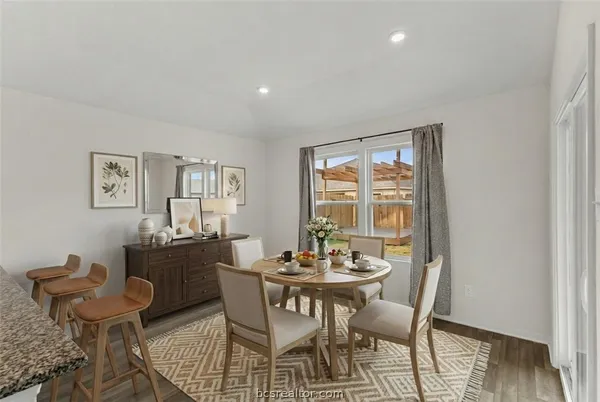 a dining room with furniture and wooden floor