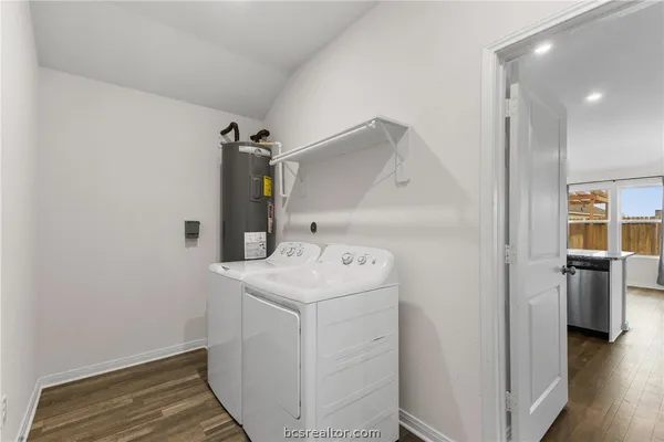 a utility room with cabinets washer and dryer
