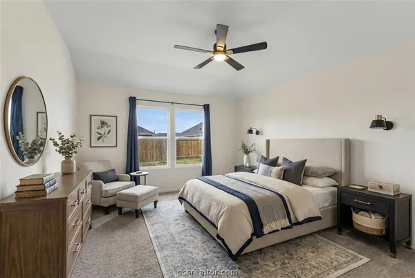 a bedroom with a bed a couch and a window