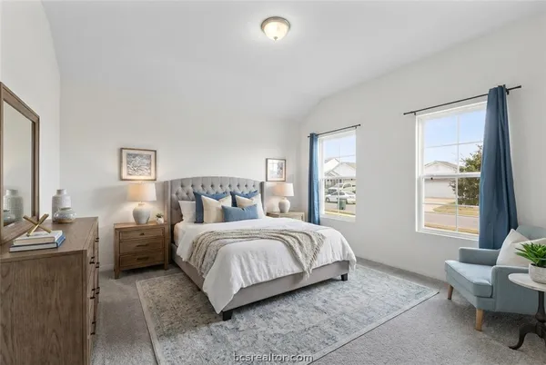 a bedroom with a bed and a couch