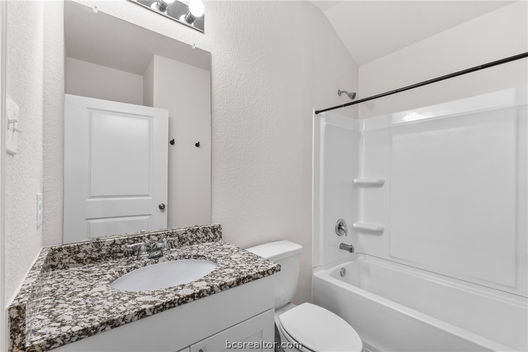 6018 Crest Bridge Bryan, TX 77807 - Photo 23 of 30 a bathroom with a granite countertop sink toilet and shower