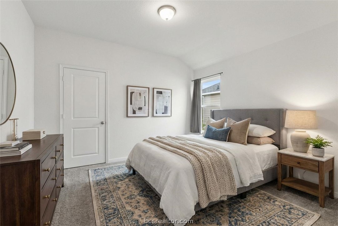 6018 Crest Bridge Bryan, TX 77807 - Photo 24 of 30 a bedroom with a bed and a chandelier