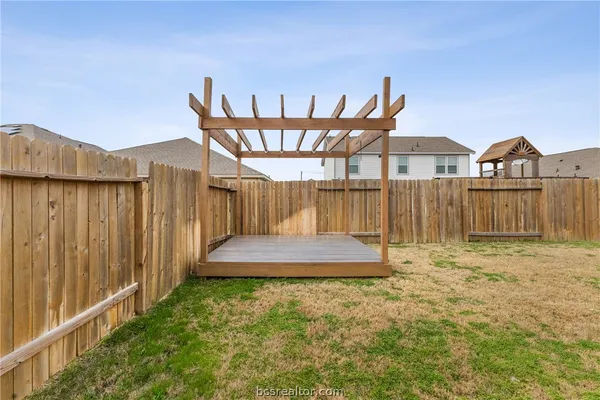 a view of a house with wooden fence