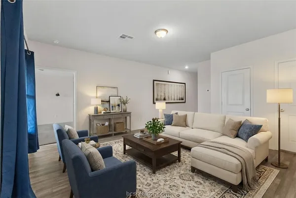 a living room with furniture or couch and a wooden floor