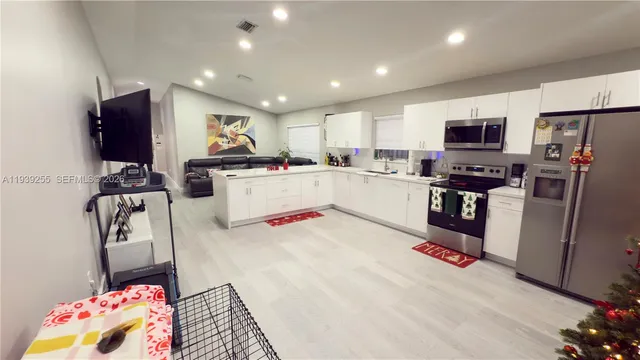 a kitchen with a refrigerator and a stove top oven