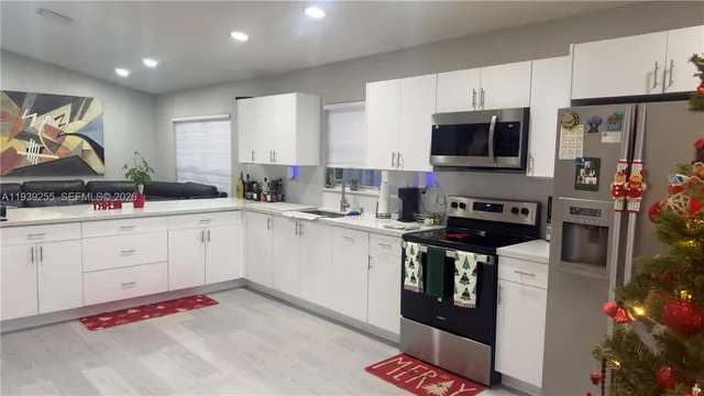 a kitchen with stainless steel appliances granite countertop a sink stove and cabinets