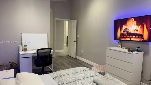 a room with a chair and a flat screen tv