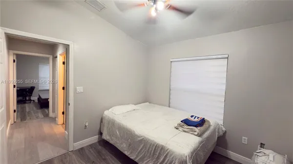 a bedroom with a bed and a hallway