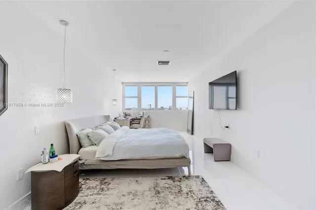 a bedroom with furniture and a wooden floor