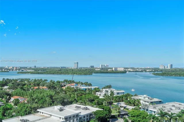 a view of a lake with houses in the back