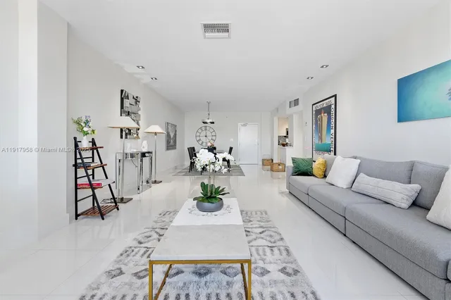 a living room with furniture a rug and white walls