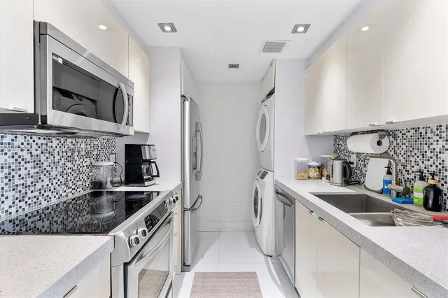 a kitchen that has a sink and a stove top oven
