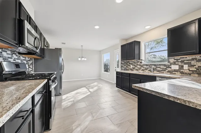 a kitchen with a sink and a large window