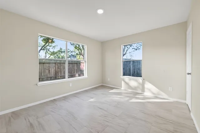 a view of a kitchen with a sink and a refrigerator