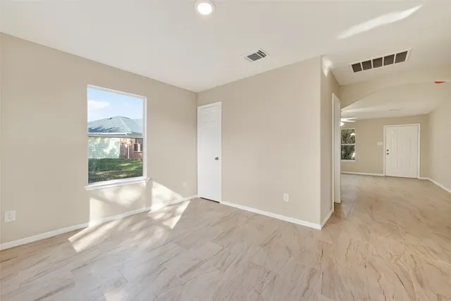 a view of a kitchen with an empty room and a window