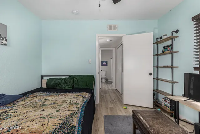 a bedroom with a bed and a desk in it